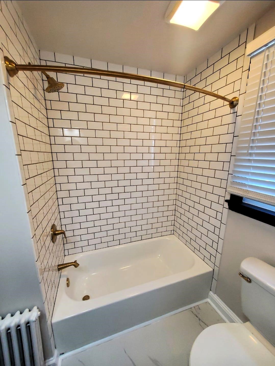 modern-bathroom-with-white-subway-tiles-and-brass-fixtures